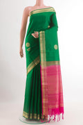 Green Soft Silk Saree with Zari Butta on the body and Zari Border.  displayed on a mannequin