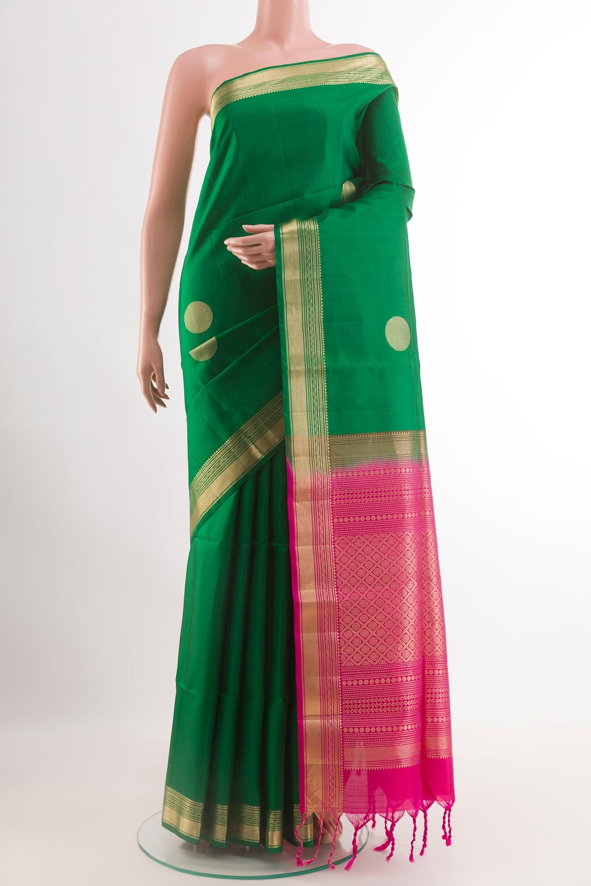 Green Soft Silk Saree with Zari Butta on the body and Zari Border.  displayed on a mannequin