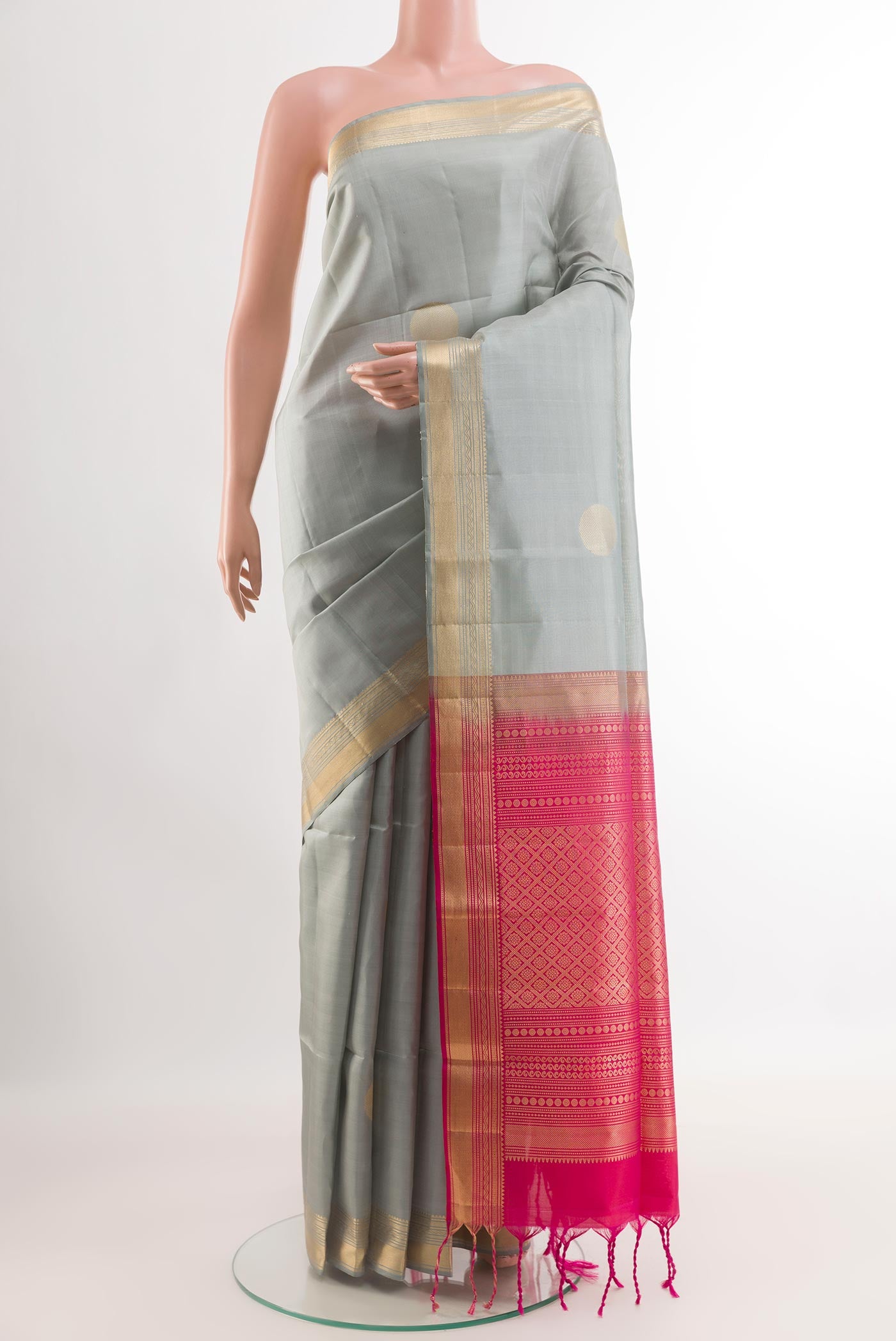 Grey Soft Silk Saree with Zari Butta on the body and Zari Border.  displayed on a mannequin