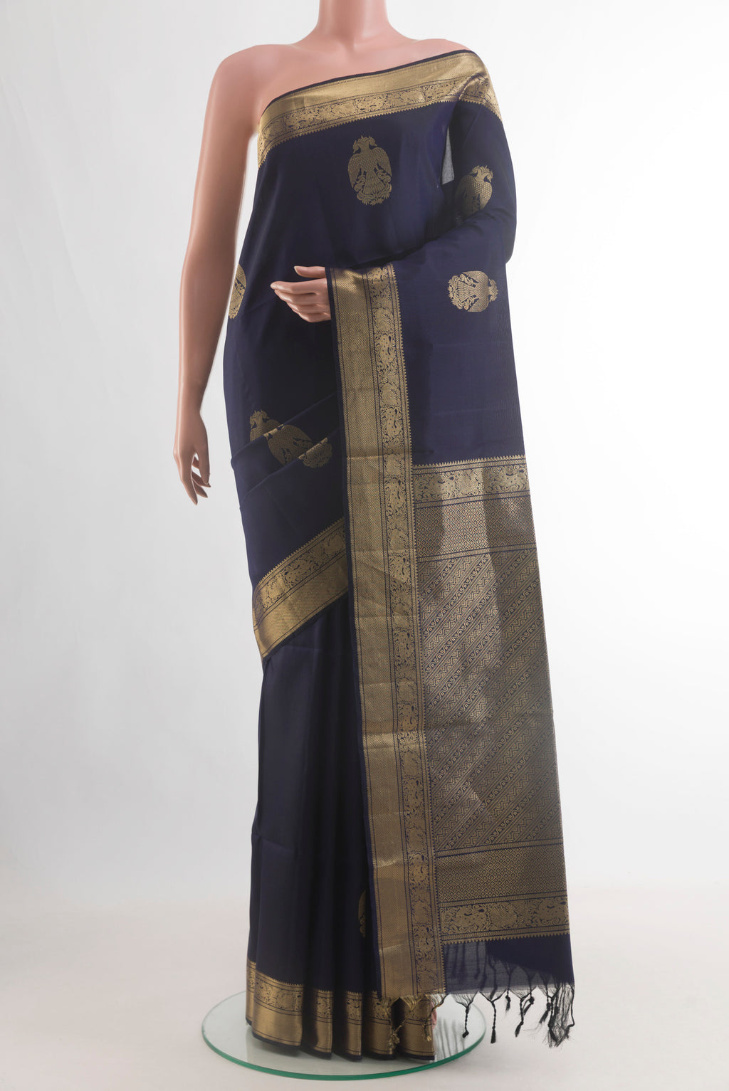 Pure Silk Navy Blue Soft Saree with Zari Butta on the body and Zari Border.  displayed on a mannequin
