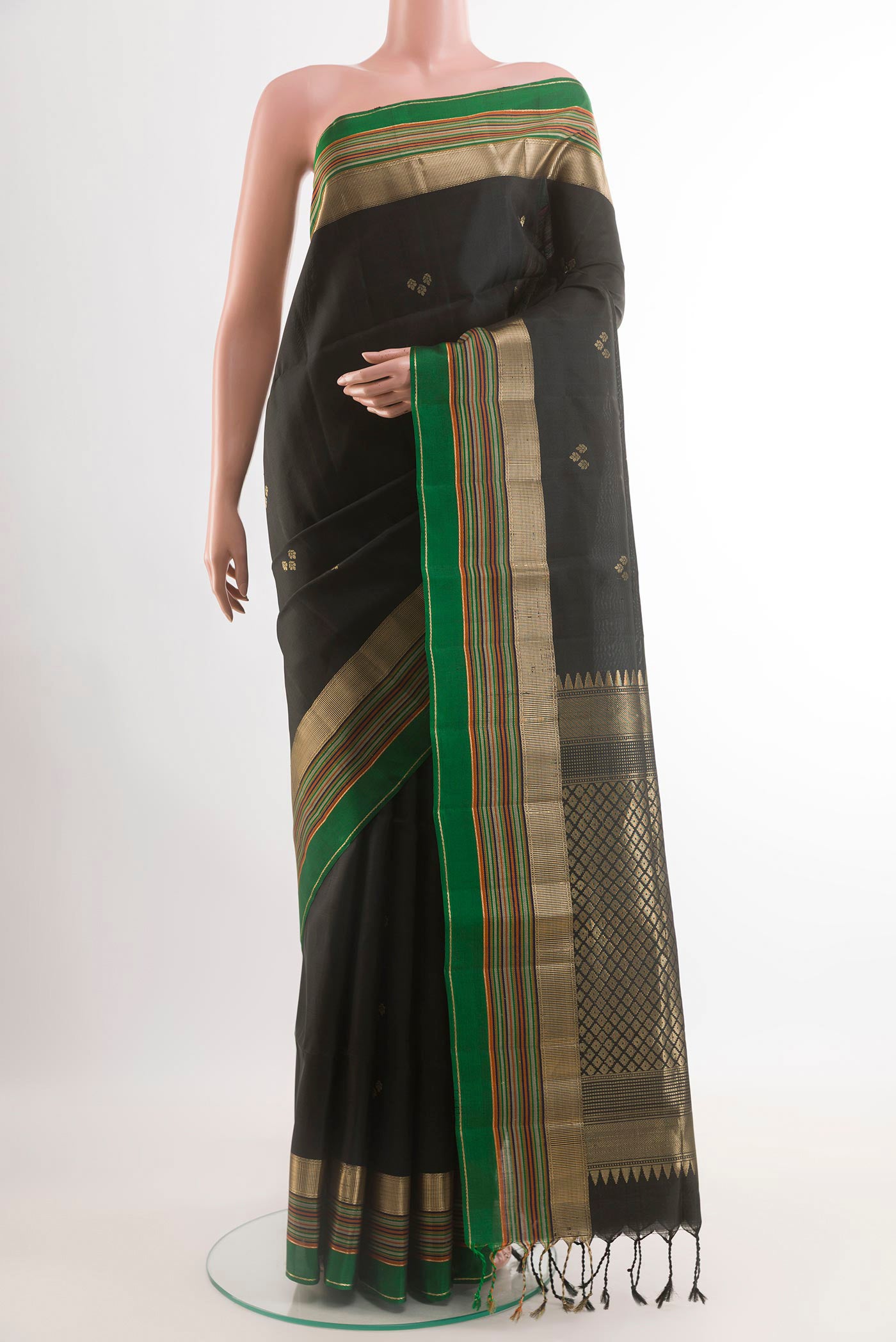 Black Soft Silk Saree with Zari Butta on the body and Zari Border.  displayed on a mannequin