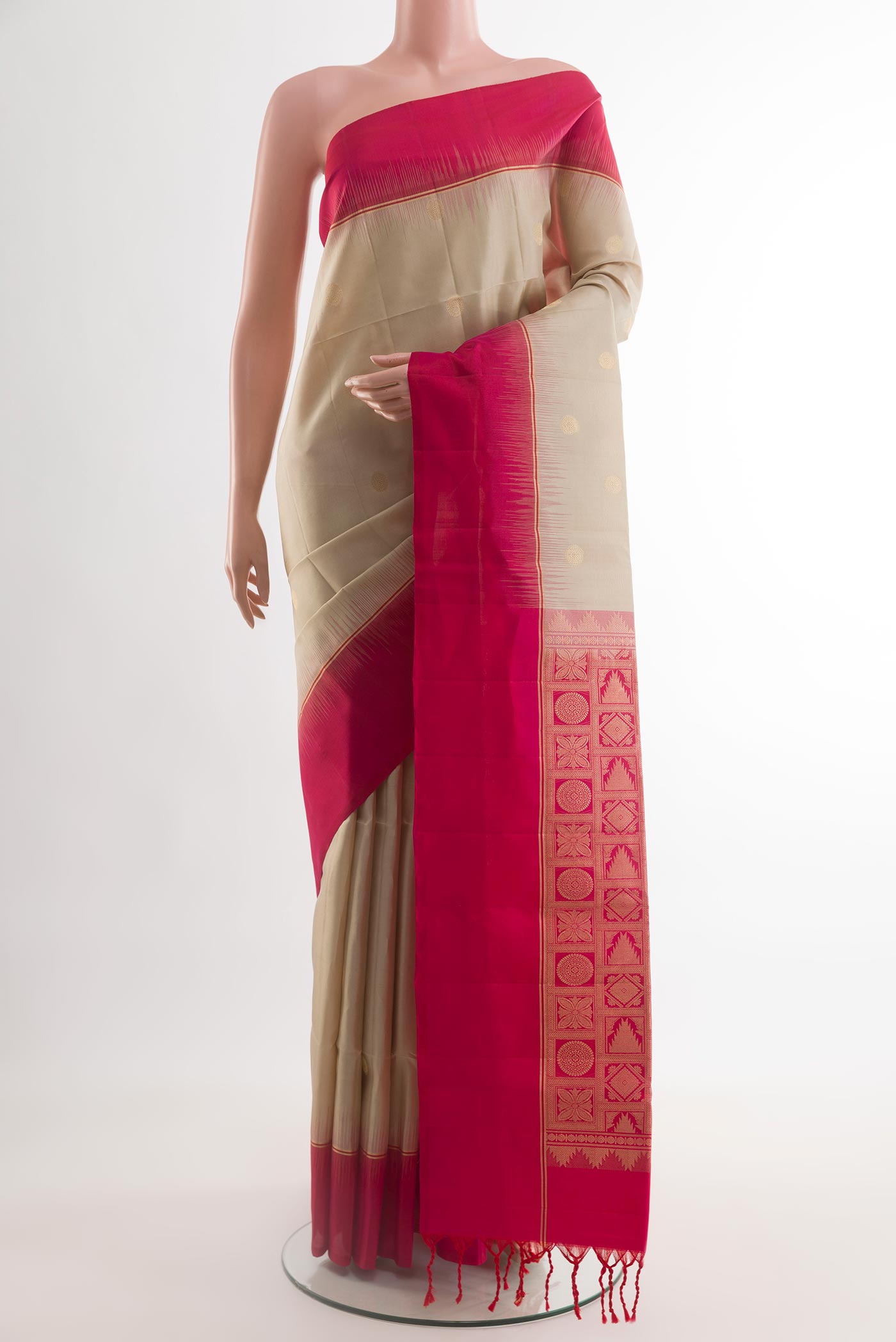 Beige Soft Silk Saree with Zari Butta on the body and Zari Border.  displayed on a mannequin