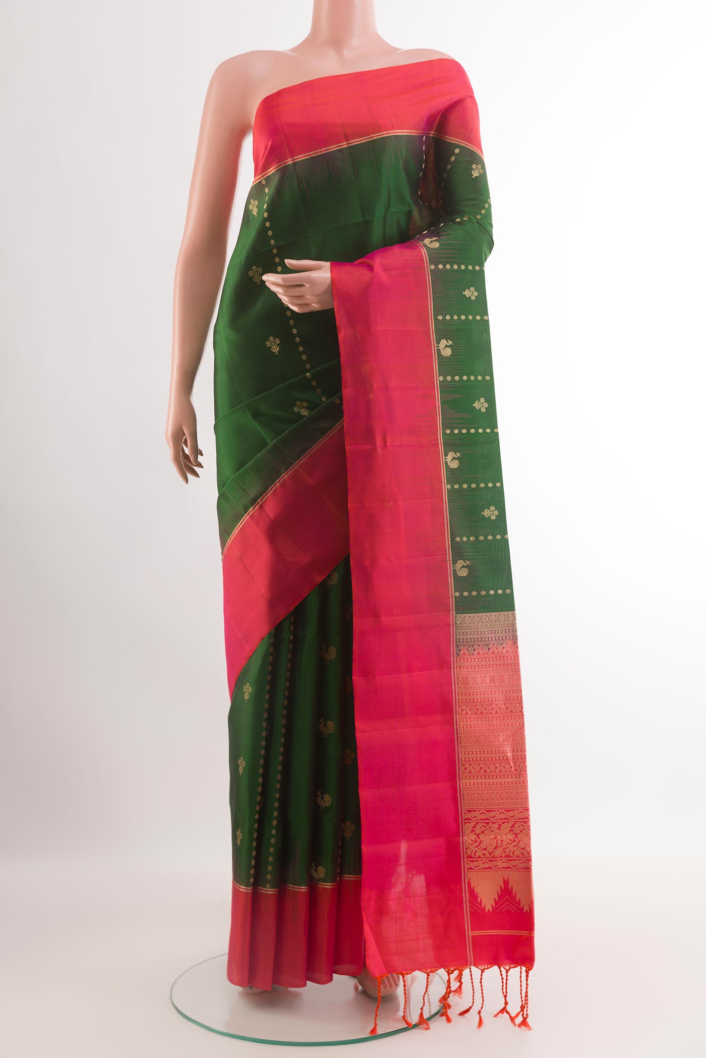 Green Soft Silk Saree with Zari Butta on the body and Zari Border.  displayed on a mannequin