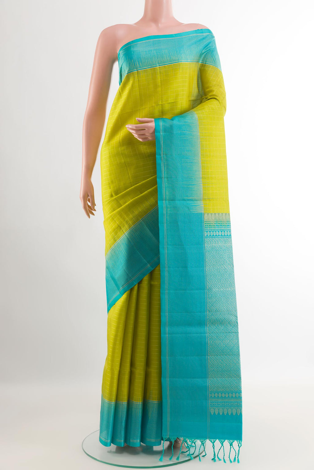 Green Soft Silk Saree with Checked design on the body and Zari Border.  displayed on a mannequin