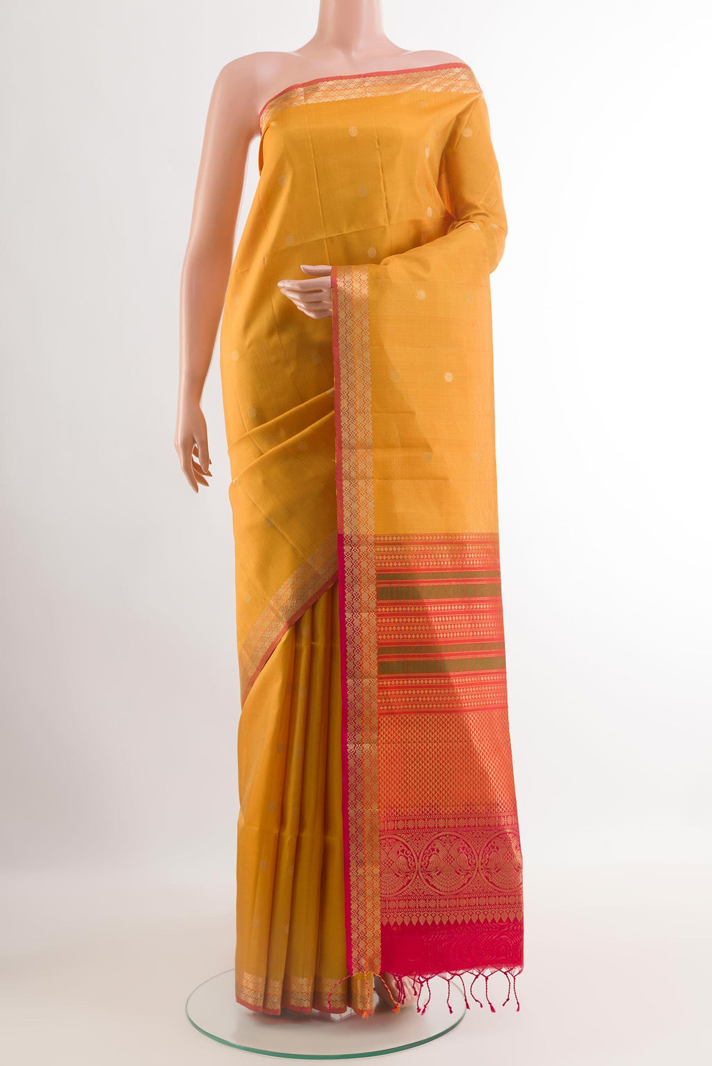 Yellow Soft Silk Saree with Zari Butta on the body and Zari Border.  displayed on a mannequin