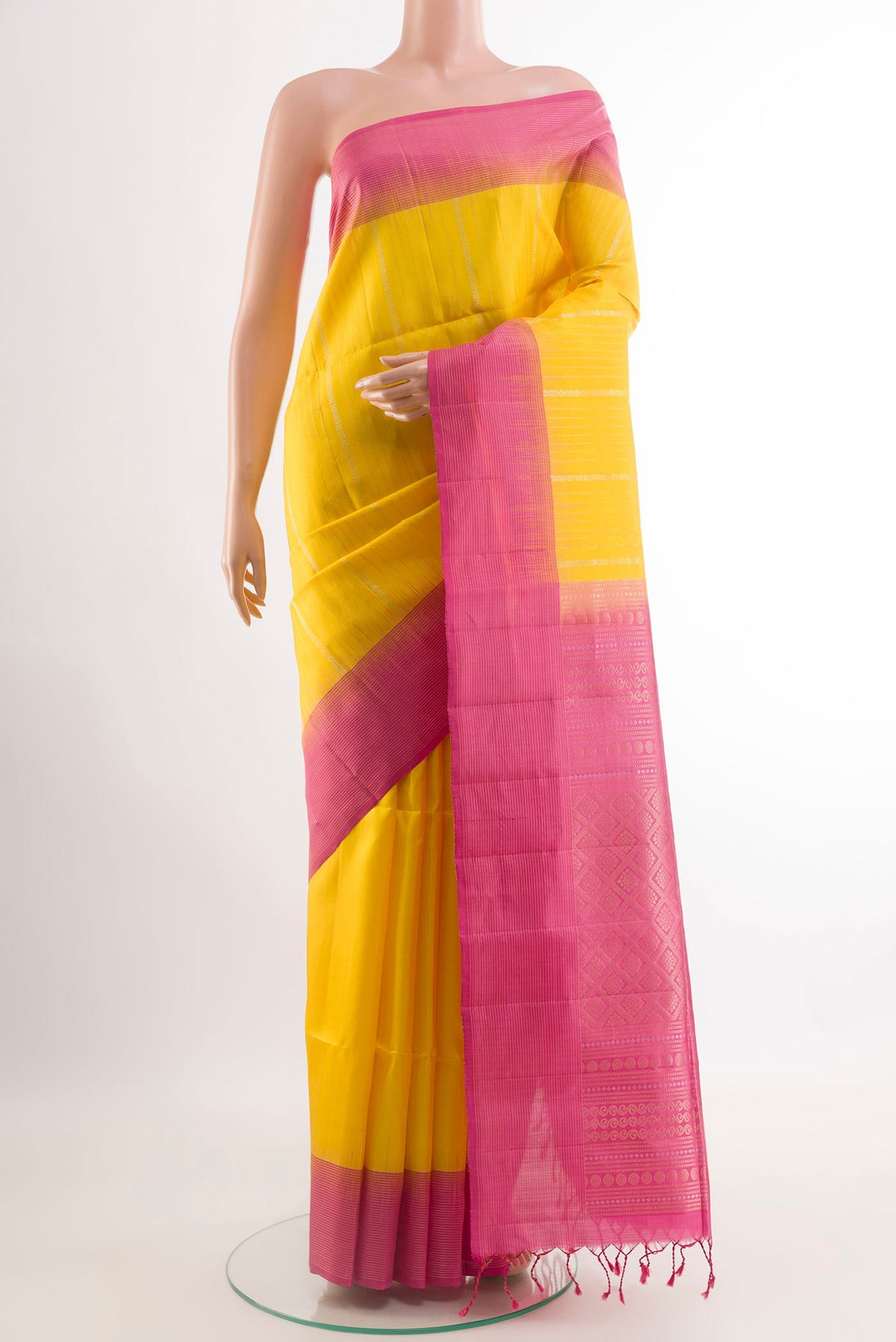 Yellow Soft Silk Saree with Stripes on the body and Zari Border.  displayed on a mannequin