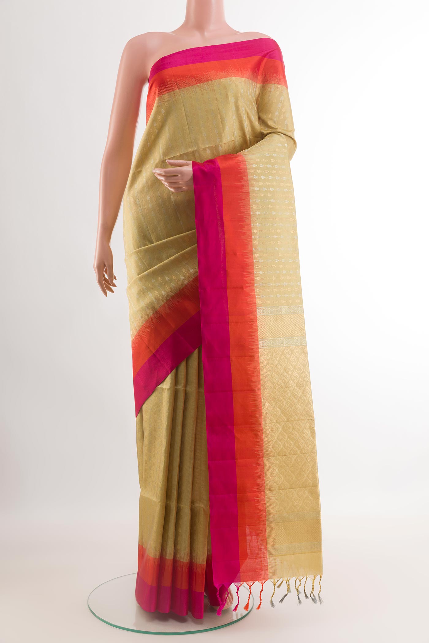 Cream Soft Silk Saree with Zari Butta on the body and Zari Border.  displayed on a mannequin