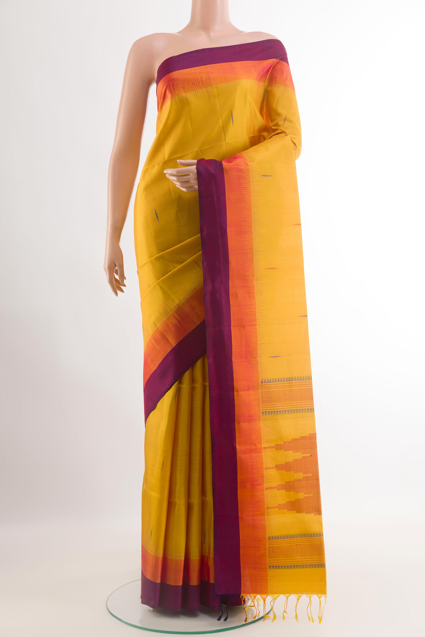 Yellow Soft Silk Saree with Thread Butta on the body and Zari Border.  displayed on a mannequin