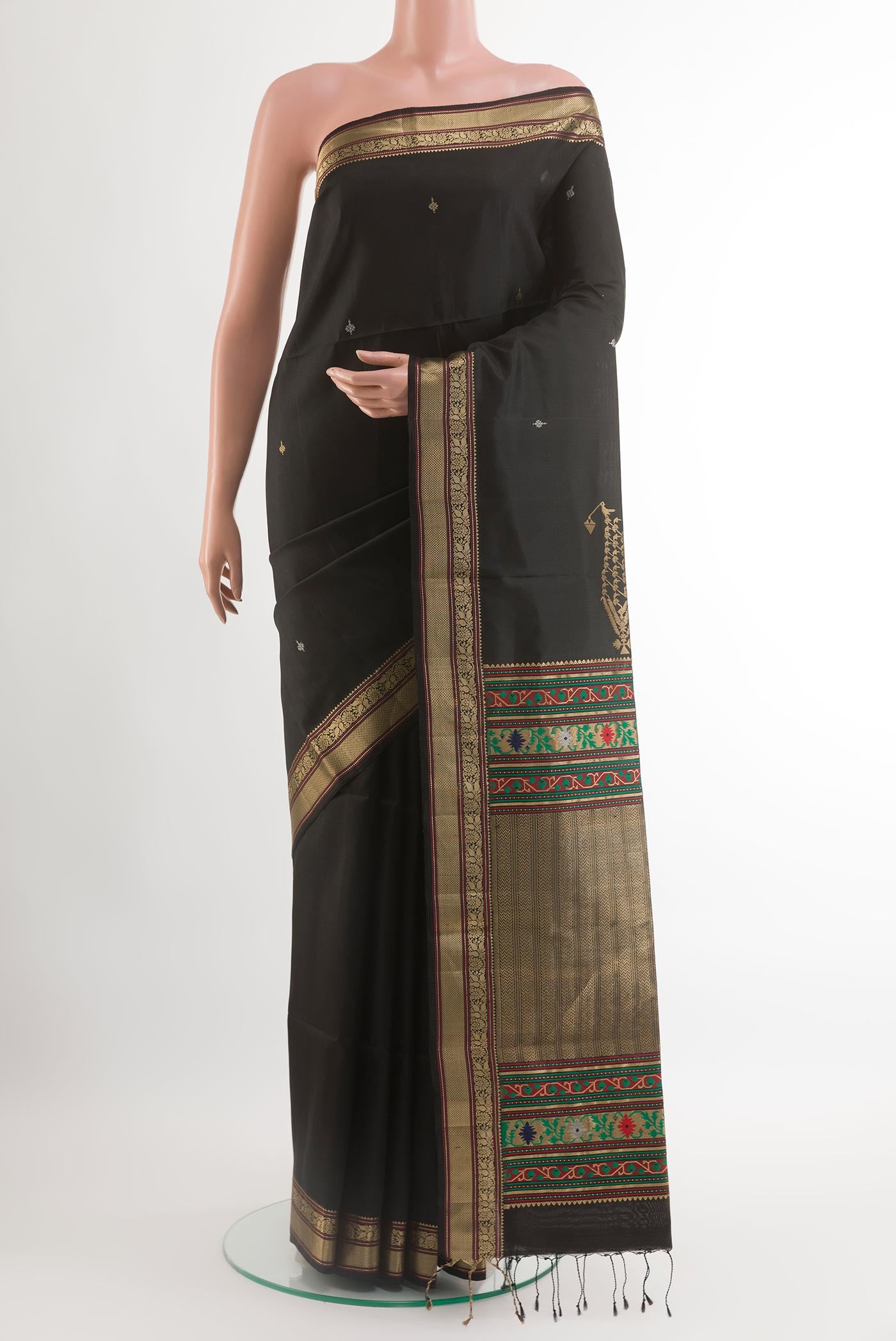 Black Soft Silk Saree with Zari Butta on the body and Zari Border.  displayed on a mannequin