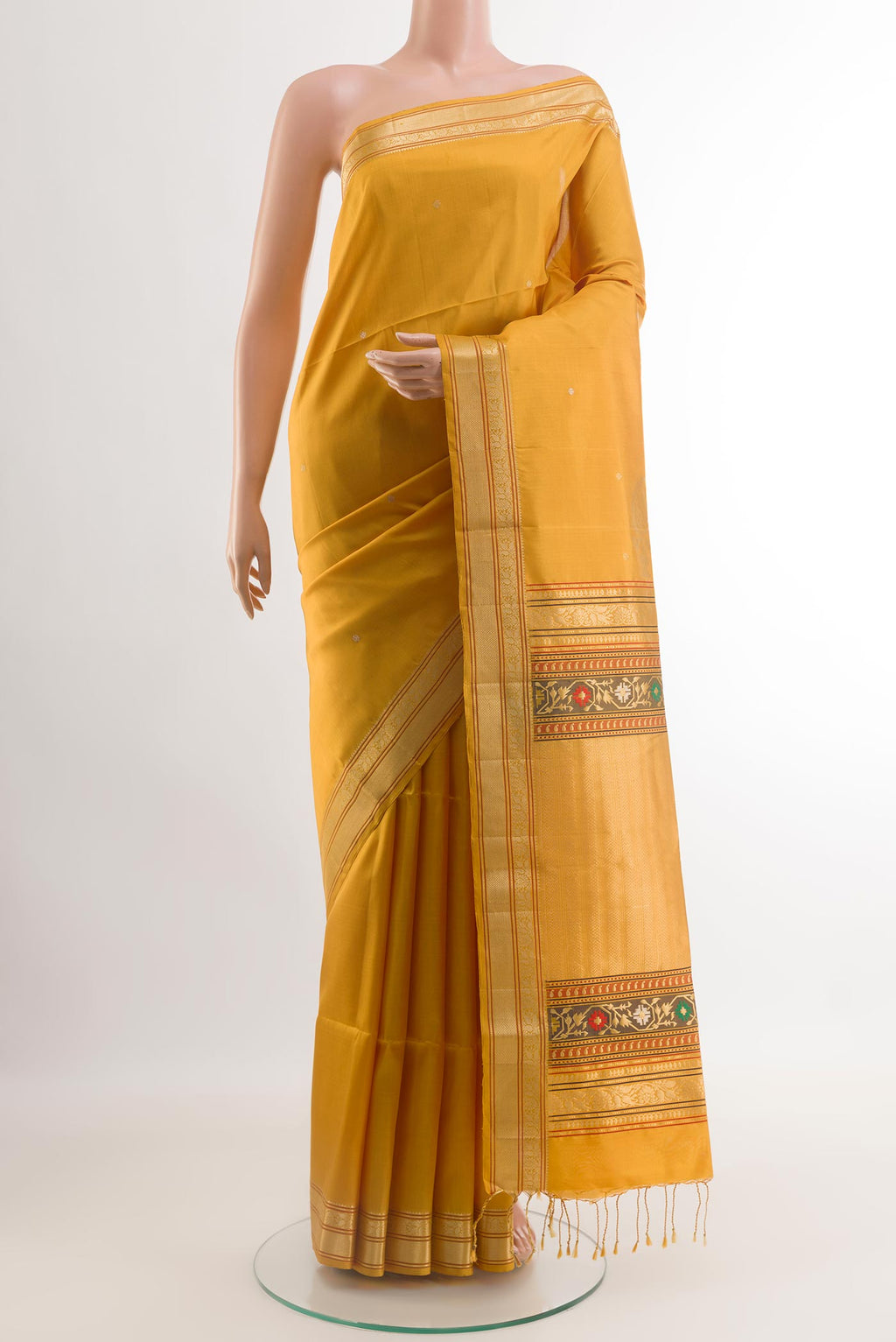 Yellow Soft Silk Saree with Zari Butta on the body and Zari Border.  displayed on a mannequin