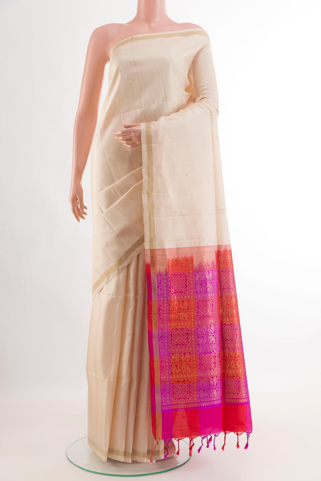 Off White Soft Silk Saree with Zari Butta on the body and Zari Border.  displayed on a mannequin