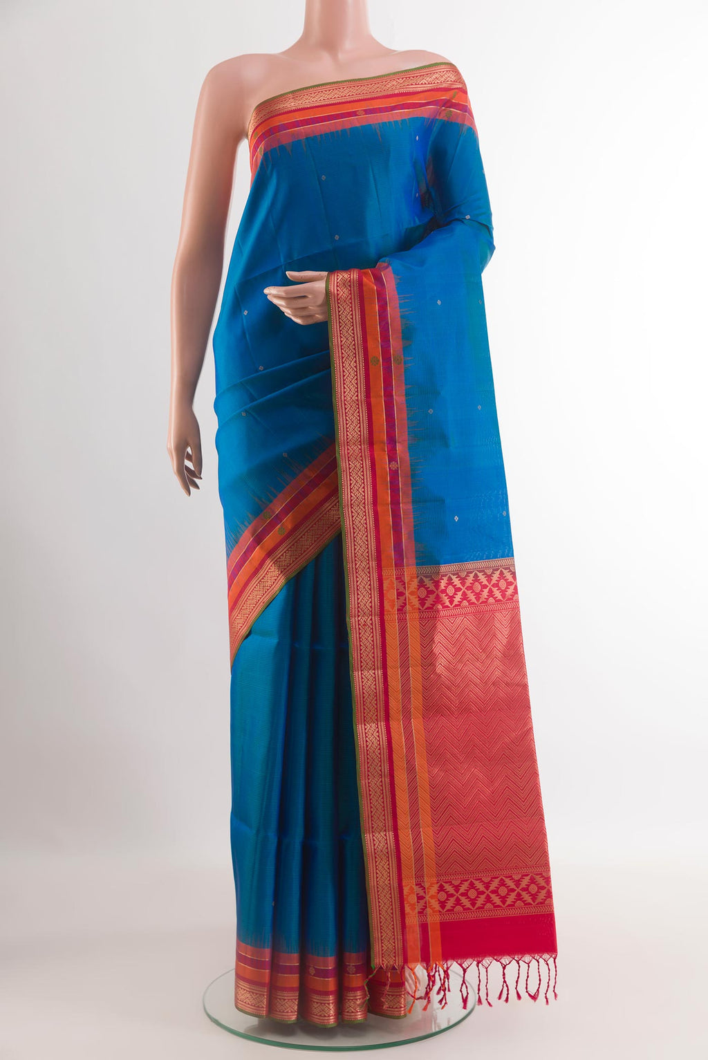 Blue Soft Silk Saree with Zari Butta on the body and Zari Border.  displayed on a mannequin
