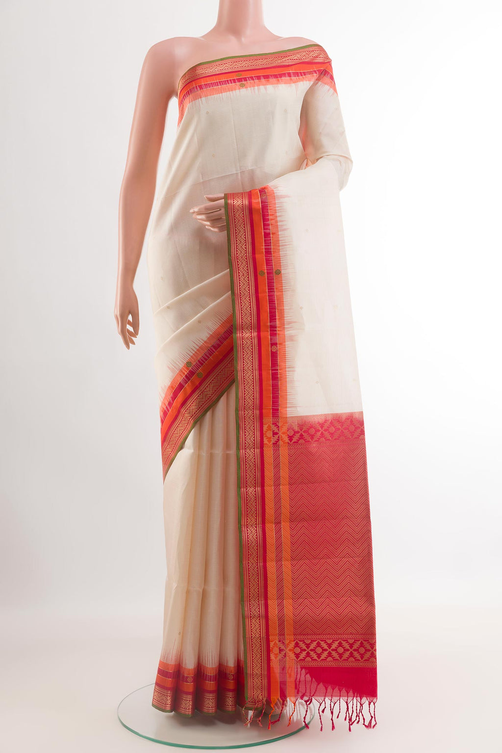 Off White Soft Silk Saree with Zari Butta on the body and Zari Border.  displayed on a mannequin