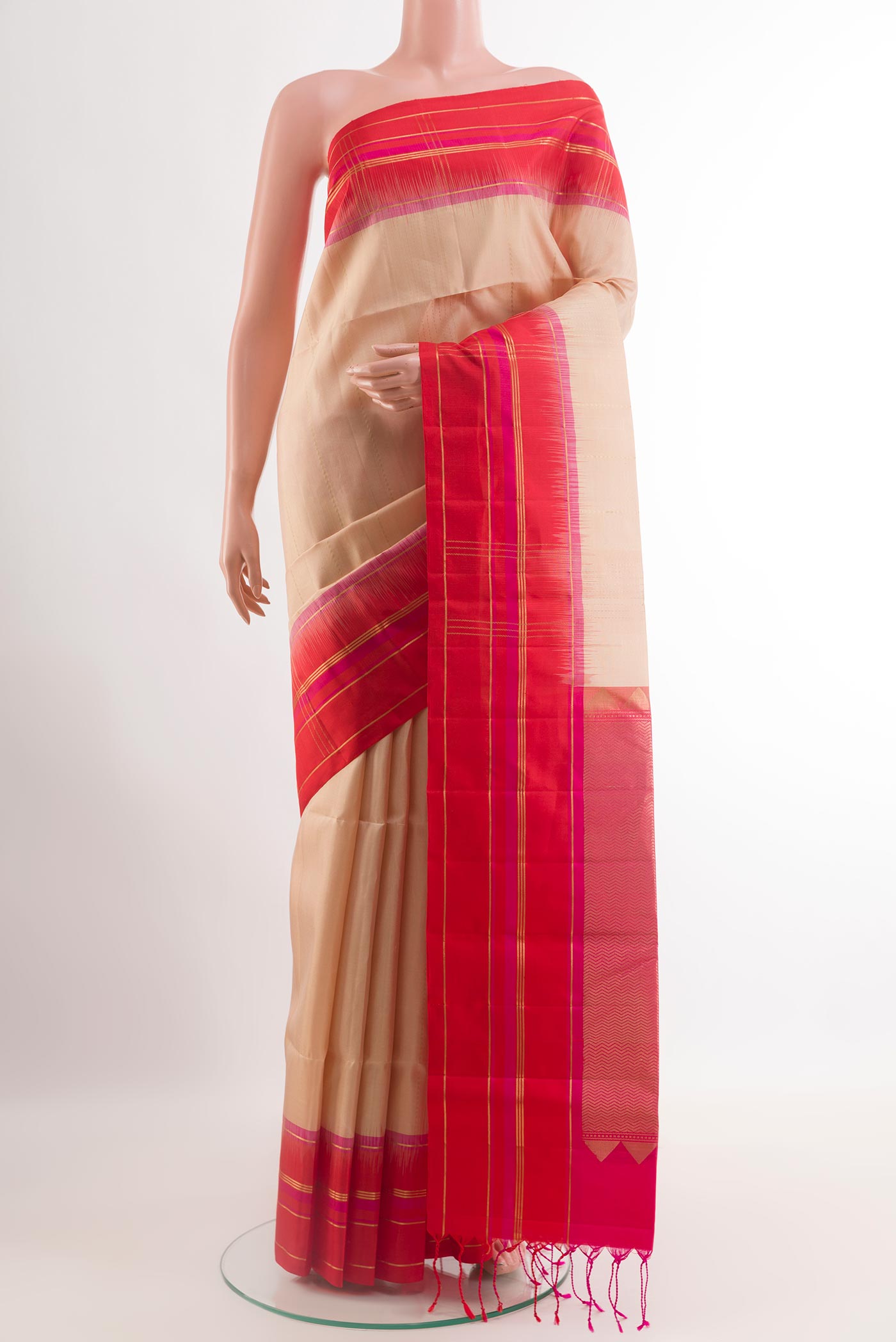Cream Soft Silk Saree with Zari Butta on the body and Zari Border.  displayed on a mannequin
