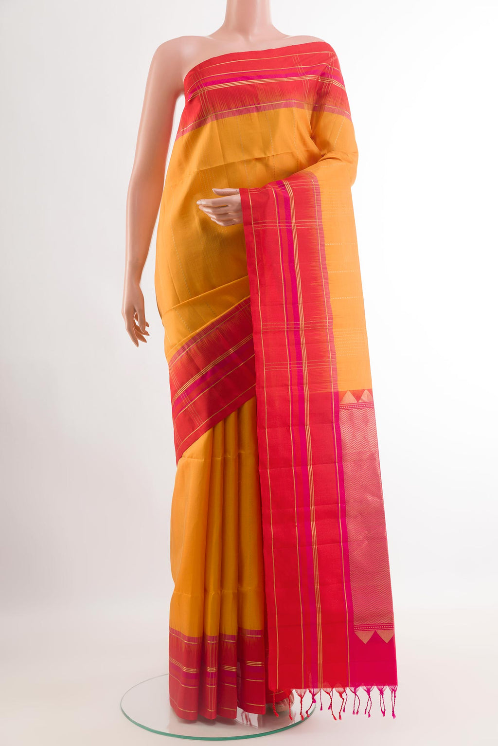 Yellow Soft Silk Saree with Stripes on the body and Zari Border.  displayed on a mannequin