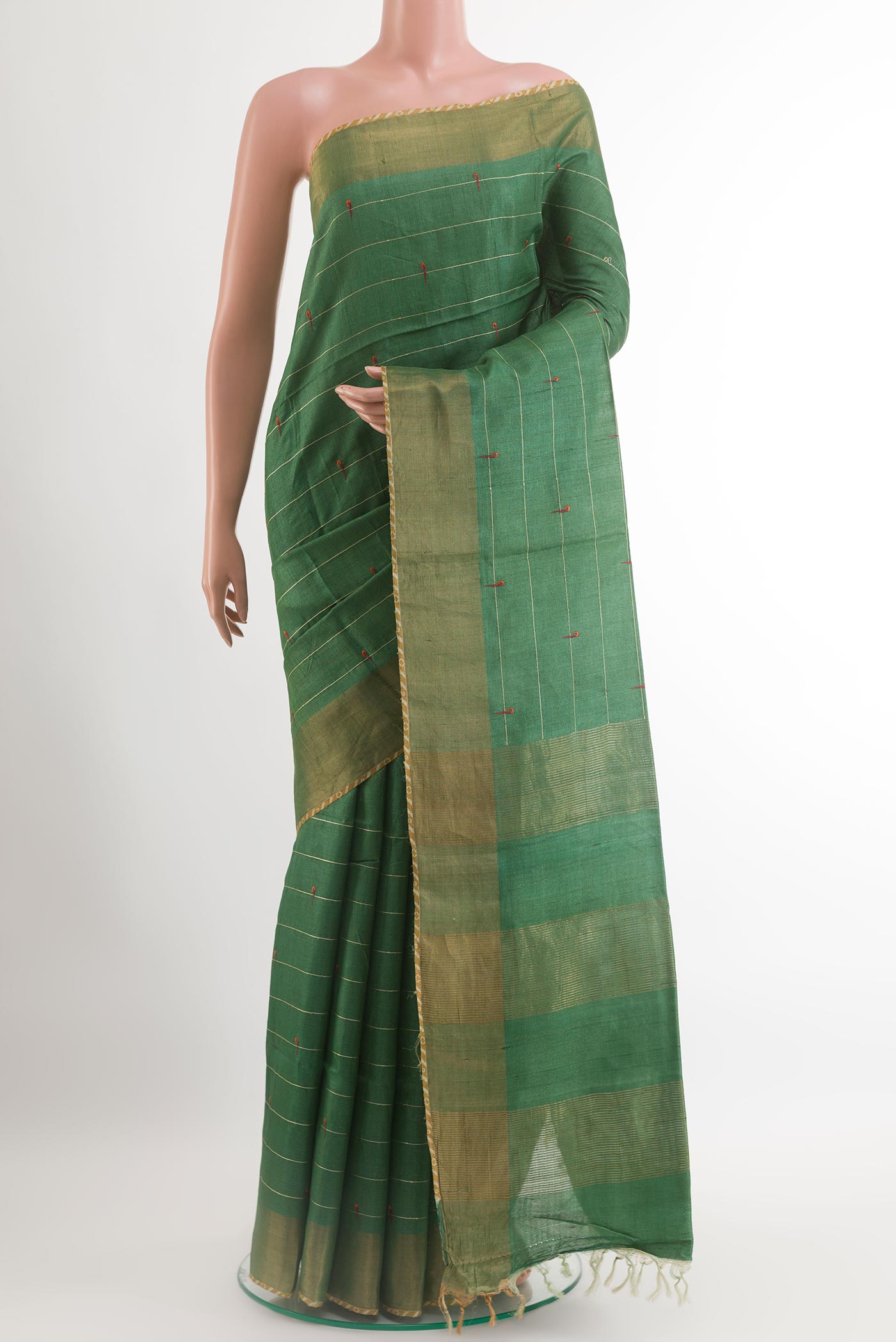 Green Tussar Saree with Thread Butta on the body and Zari Border.  displayed on a mannequin