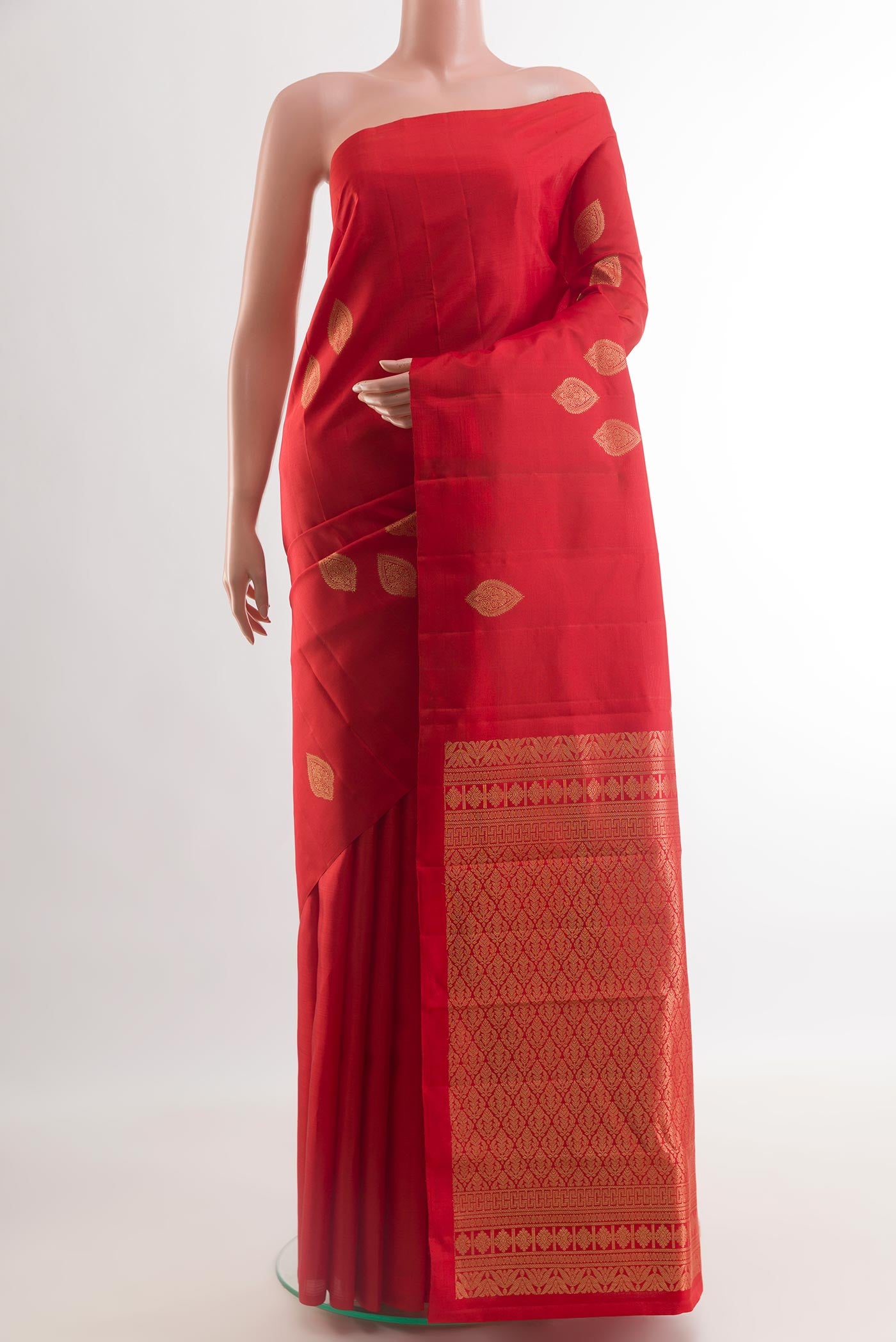 Red Kanchipuram Silk Saree with Zari Butta on the body and Without Border.  displayed on a mannequin