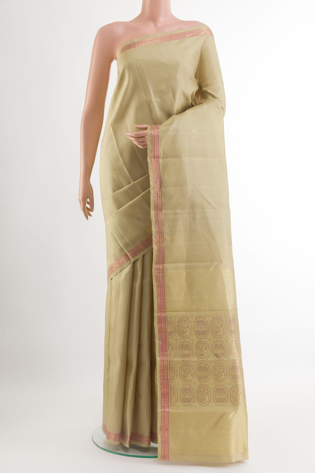 Beige Kanchipuram Silk Saree with Zari Butta on the body and Zari Border.  displayed on a mannequin