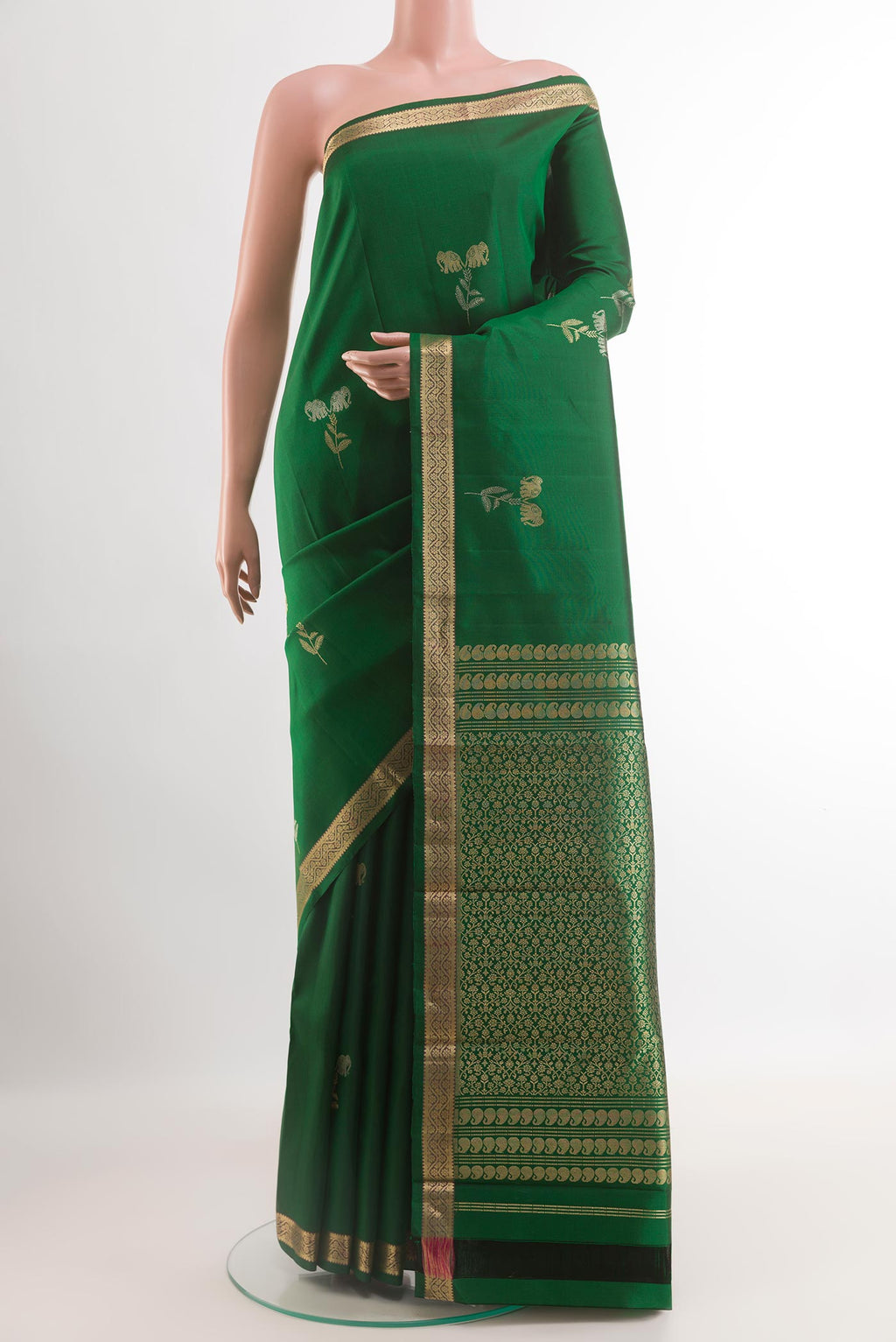 Green Kanchipuram Silk Saree with Zari Butta on the body and Zari Border.  displayed on a mannequin