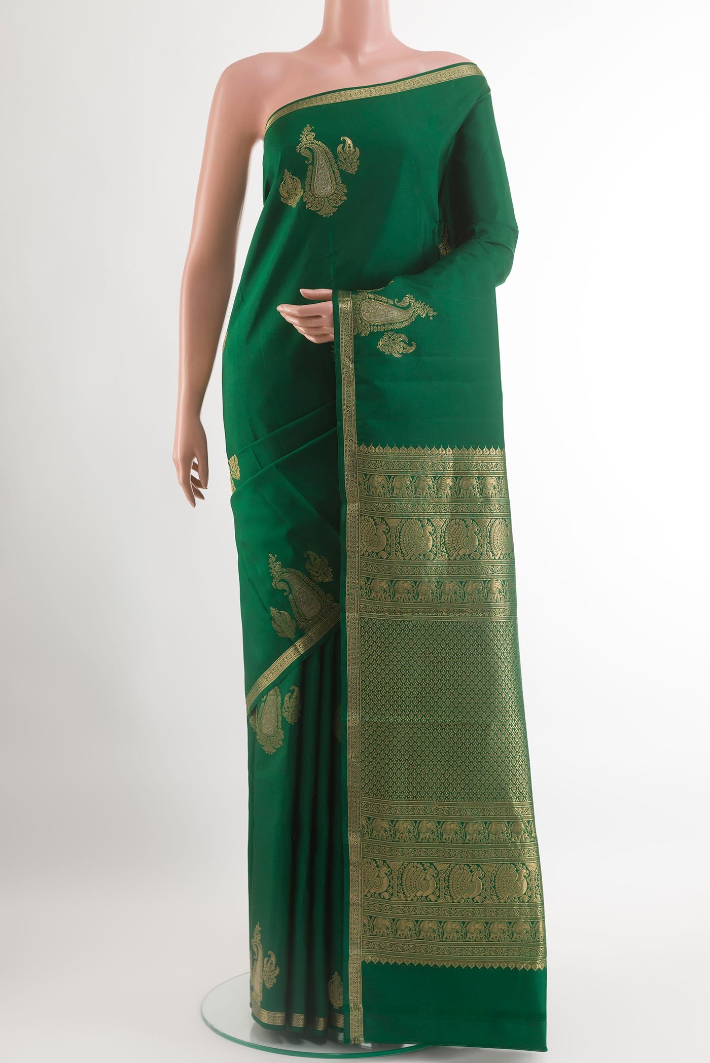 Green Kanchipuram Silk Saree with Zari Butta on the body and Zari Border.  displayed on a mannequin
