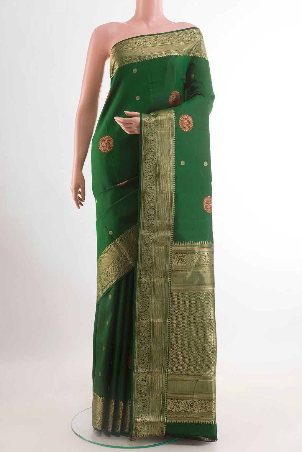 Green Kanchipuram Silk Saree with Zari Butta on the body and Zari Border.  displayed on a mannequin