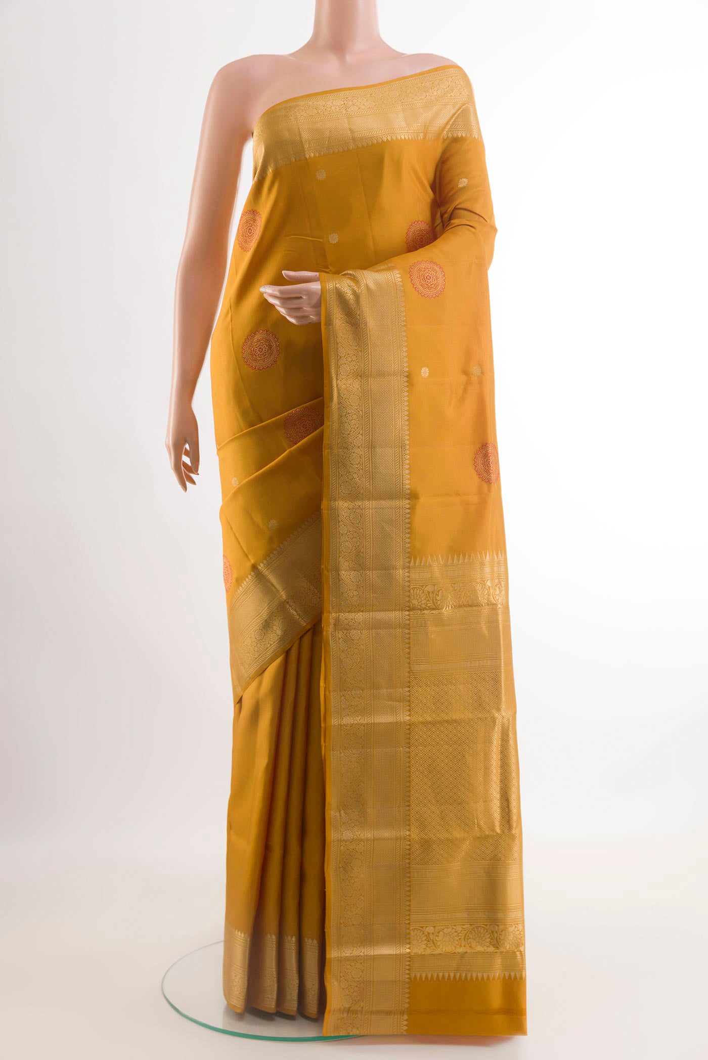 Yellow Kanchipuram Silk Saree with Zari Butta on the body and Zari Border.  displayed on a mannequin