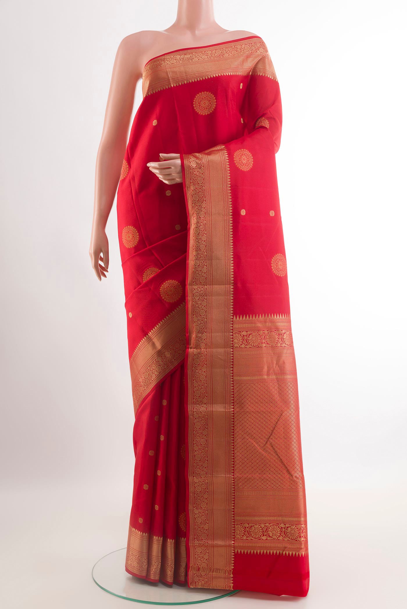 Red Kanchipuram Silk Saree with Zari Butta on the body and Zari Border.  displayed on a mannequin