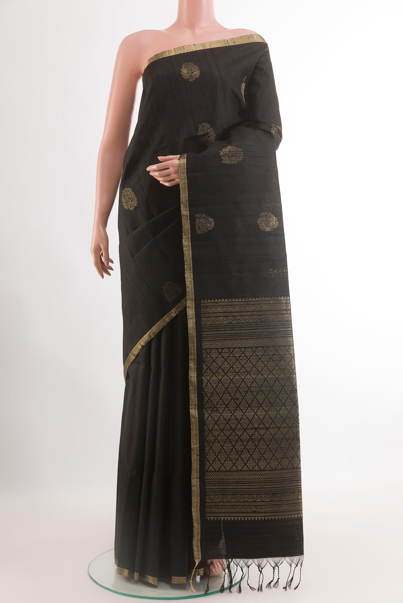 Black Raw Silk Saree with Zari Butta on the body and Zari Border.  displayed on a mannequin