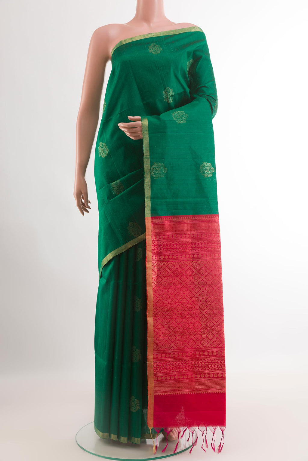 Green Raw Silk Saree with Zari Butta on the body and Zari Border.  displayed on a mannequin