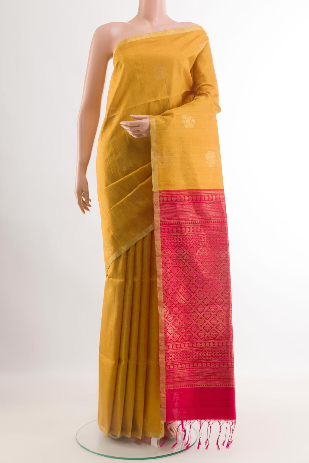 Yellow Raw Silk Saree with Zari Butta on the body and Zari Border.  displayed on a mannequin
