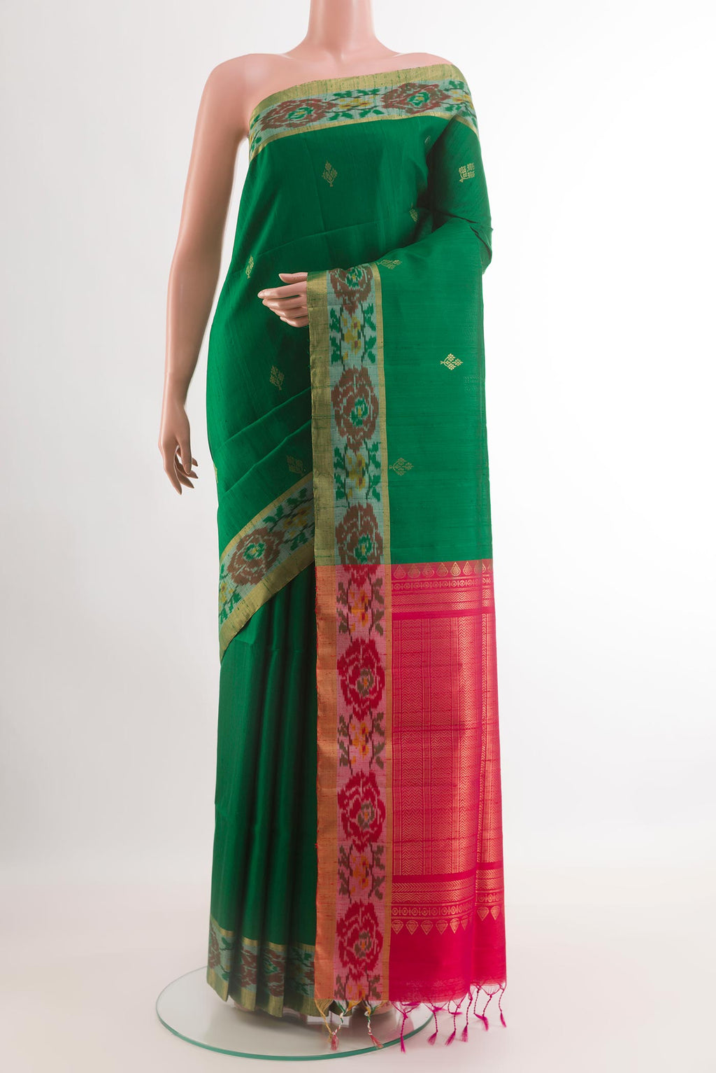 Green Raw Silk Saree with Zari Butta on the body and Zari Border.  displayed on a mannequin