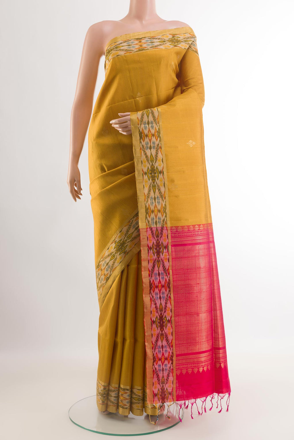 Yellow Raw Silk Saree with Zari Butta on the body and Zari Border.  displayed on a mannequin
