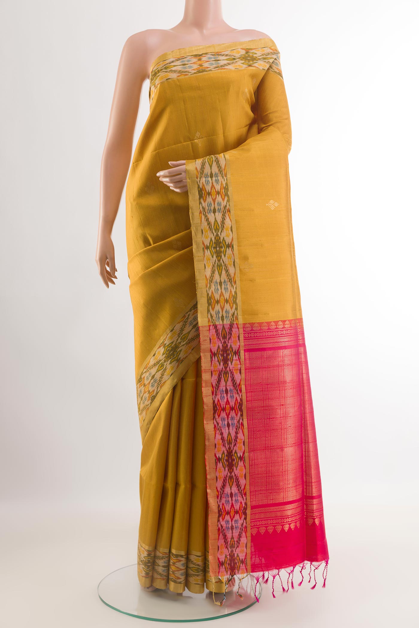 Yellow Raw Silk Saree with Zari Butta on the body and Zari Border.  displayed on a mannequin