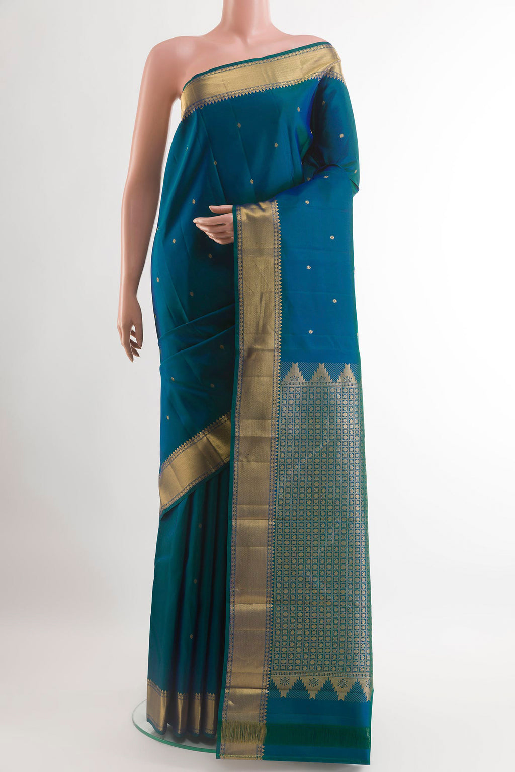 Peacock Blue Kanjivaram Silk Saree with Zari Butta on the body and Zari Border.  displayed on a mannequin
