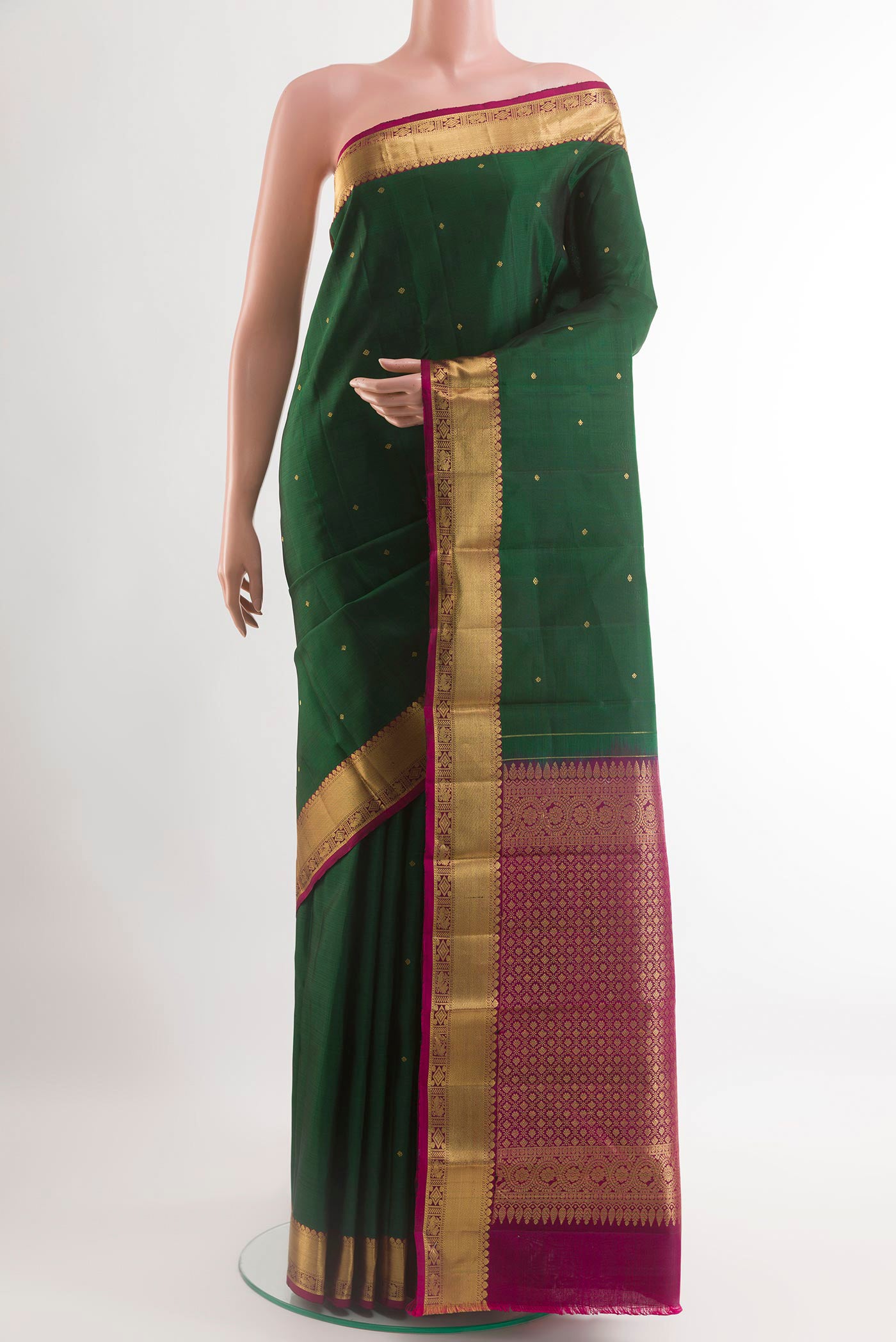 Green Kanchipuram Silk Saree with Zari Butta on the body and Zari Border.  displayed on a mannequin