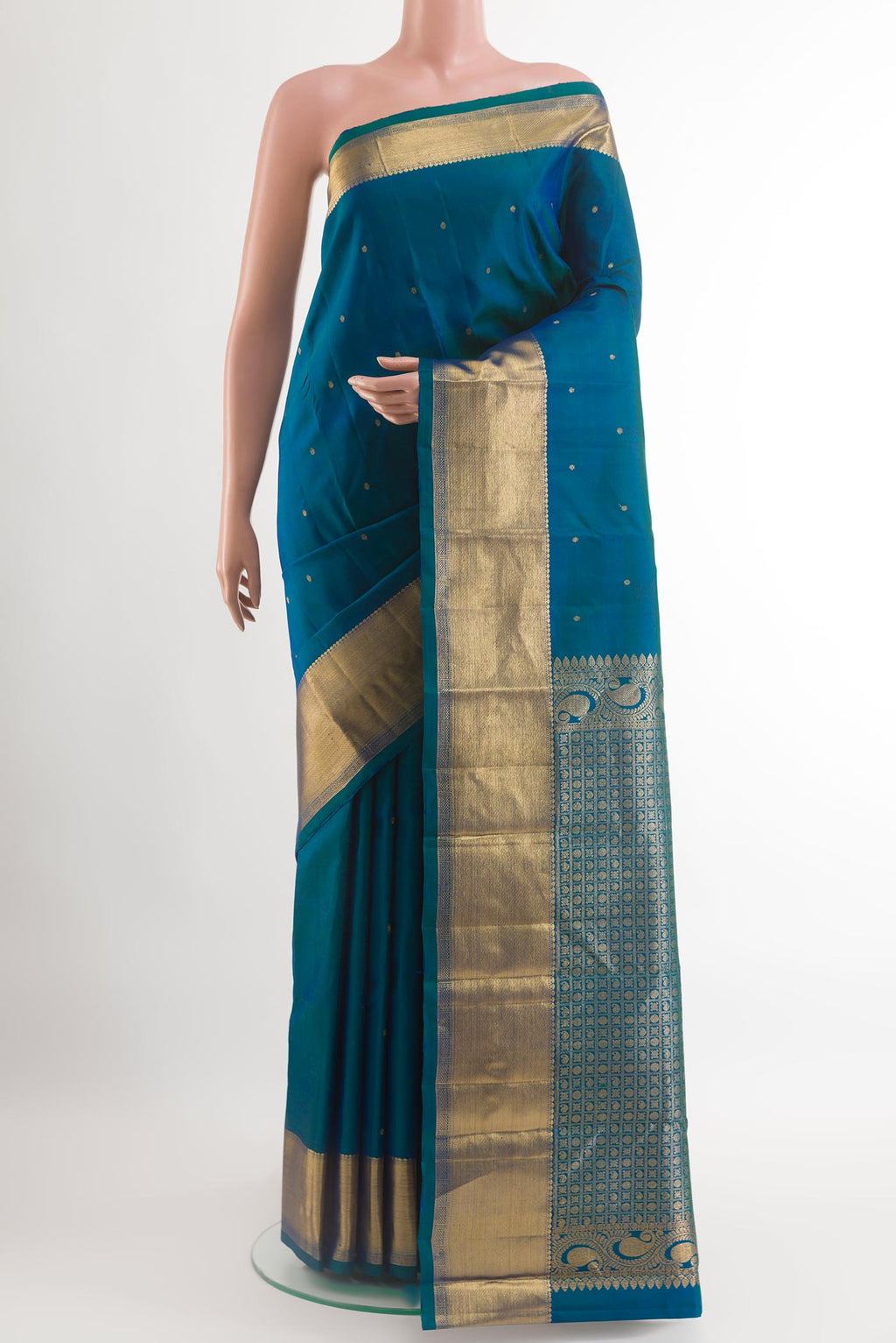 Peacock Blue Kanchipuram Silk Saree with Zari Butta on the body and Zari Border.  displayed on a mannequin
