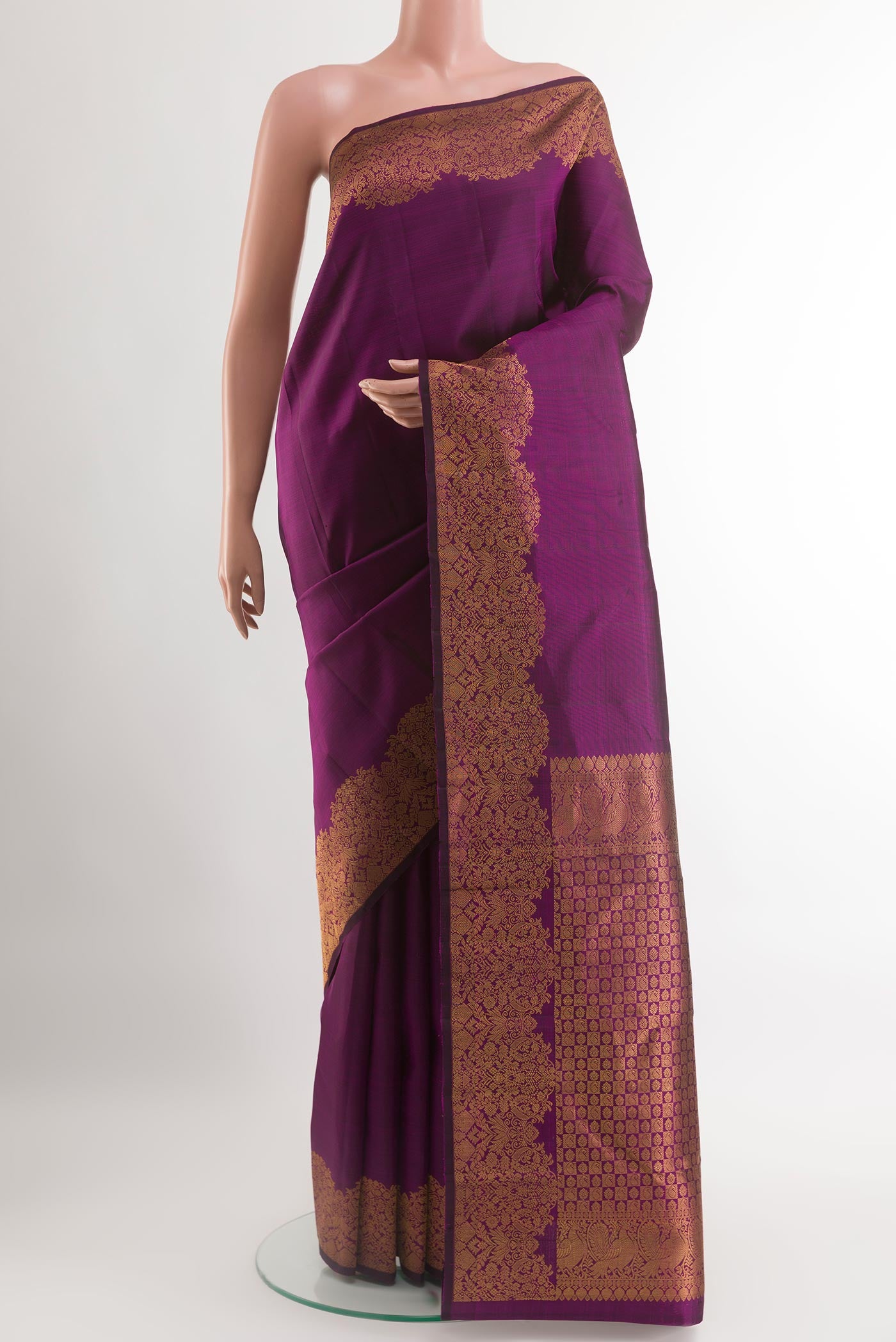 Purple Kanchipuram Silk Saree with Plain Body and Zari Border.  displayed on a mannequin