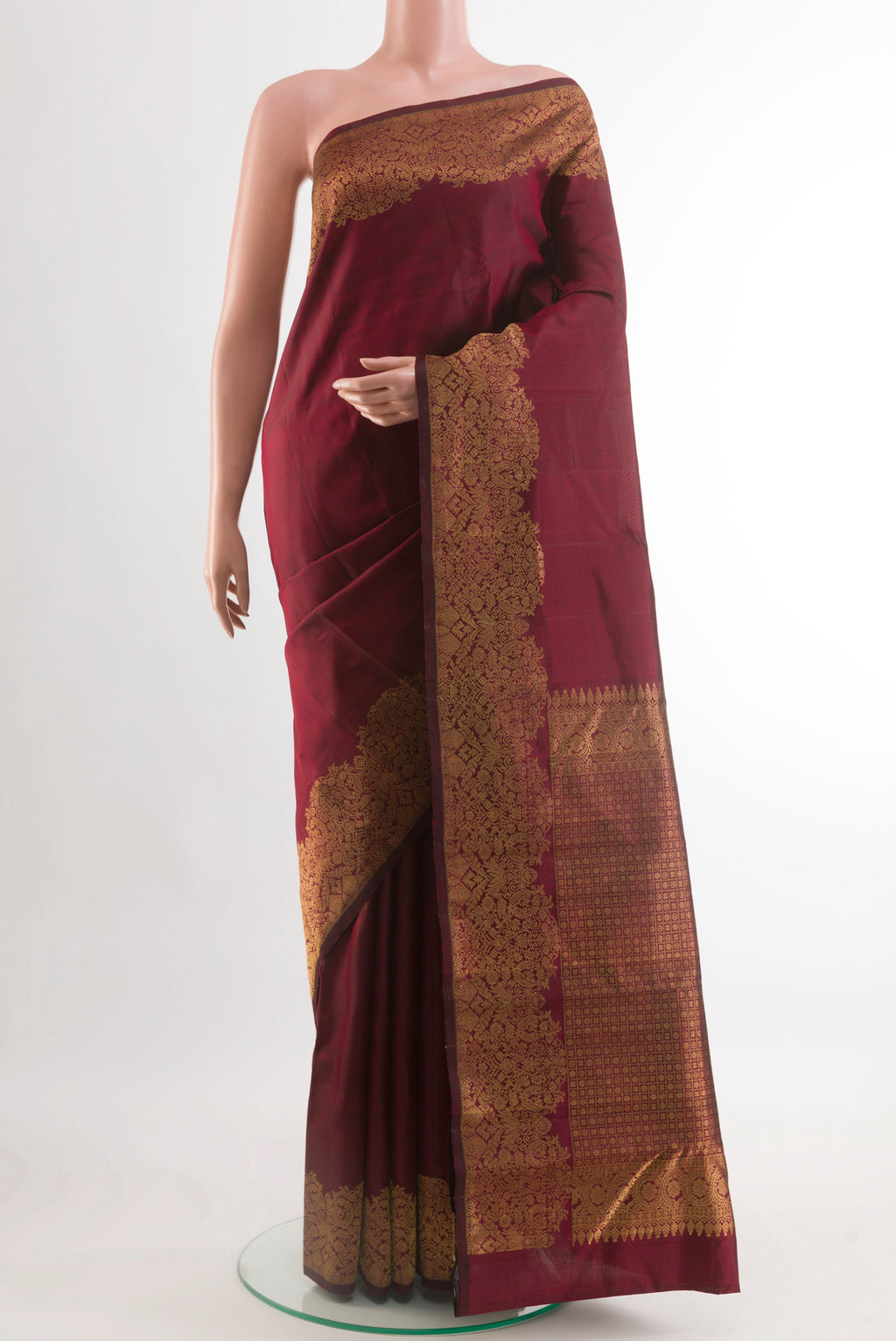 Maroon Kanchipuram Silk Saree with Zari Butta on the body and Zari Border.  displayed on a mannequin