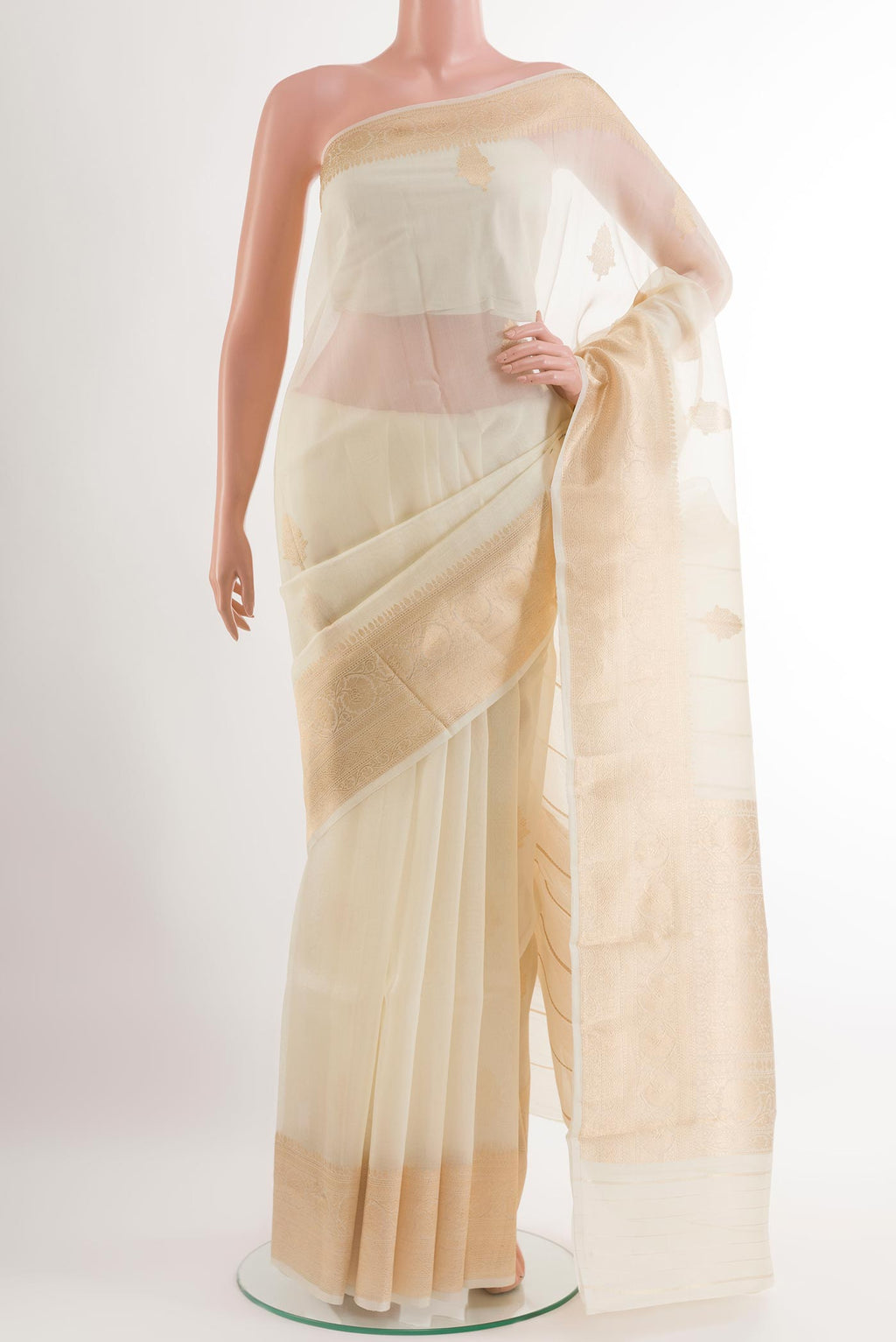 Off White Organza Silk Saree with Zari Butta on the body and Zari Border.  displayed on a mannequin