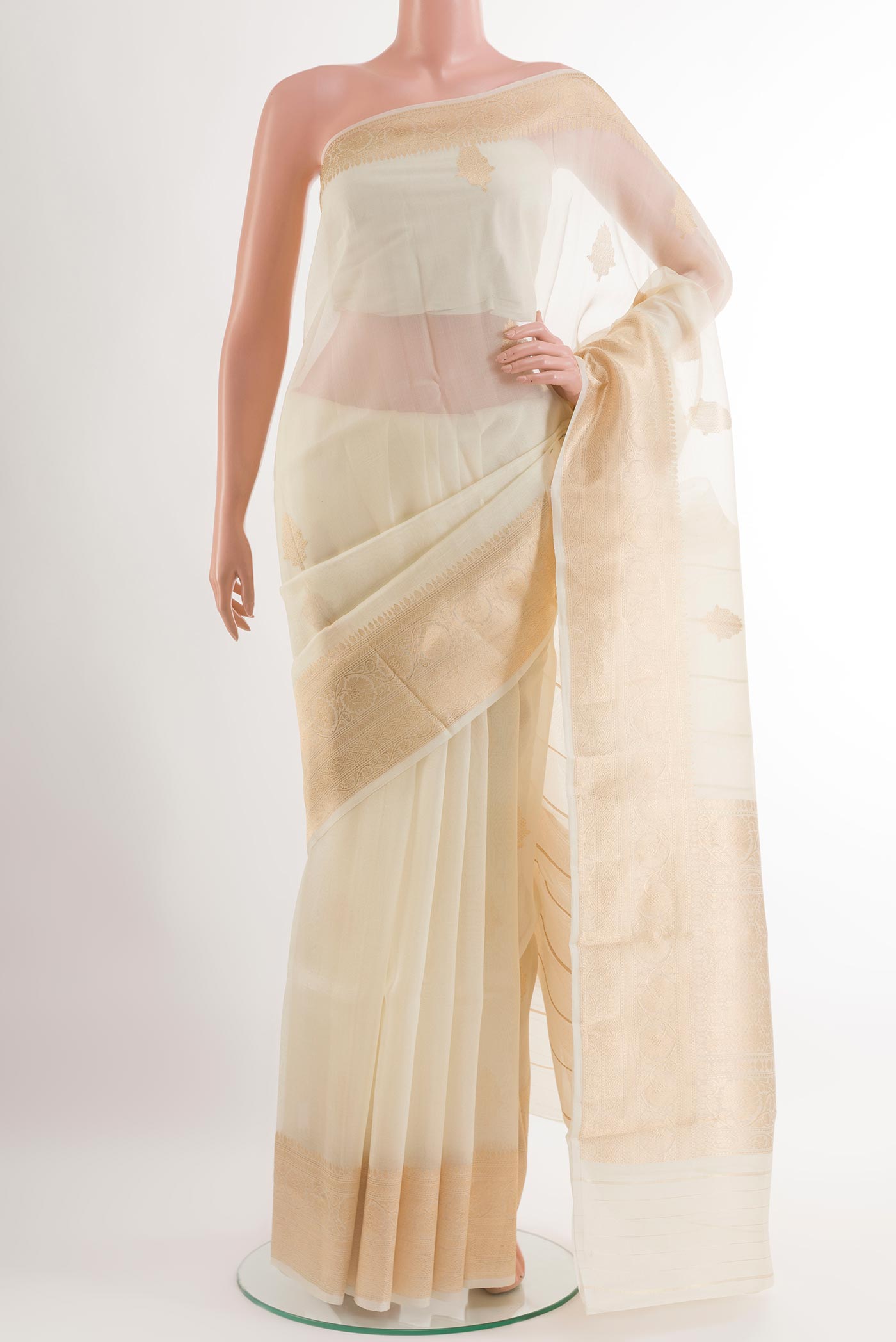 Off White Organza Silk Saree with Zari Butta on the body and Zari Border.  displayed on a mannequin