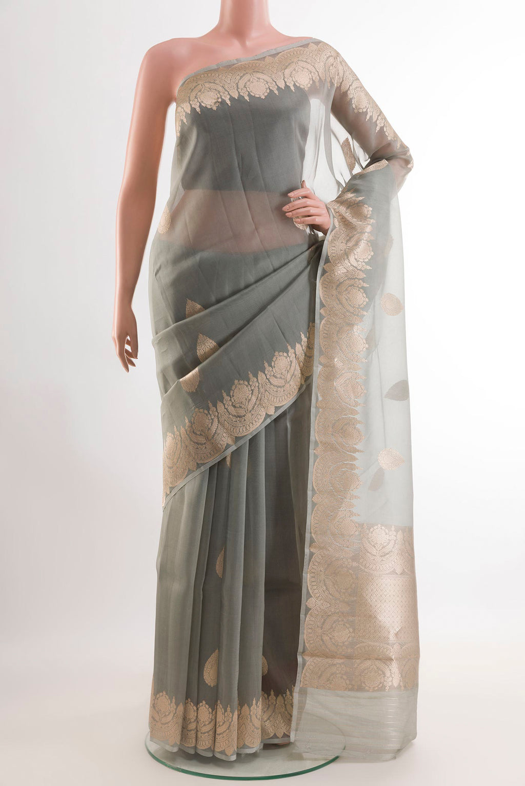 Grey Organza Silk Saree with Zari Butta on the body and Zari Border.  displayed on a mannequin