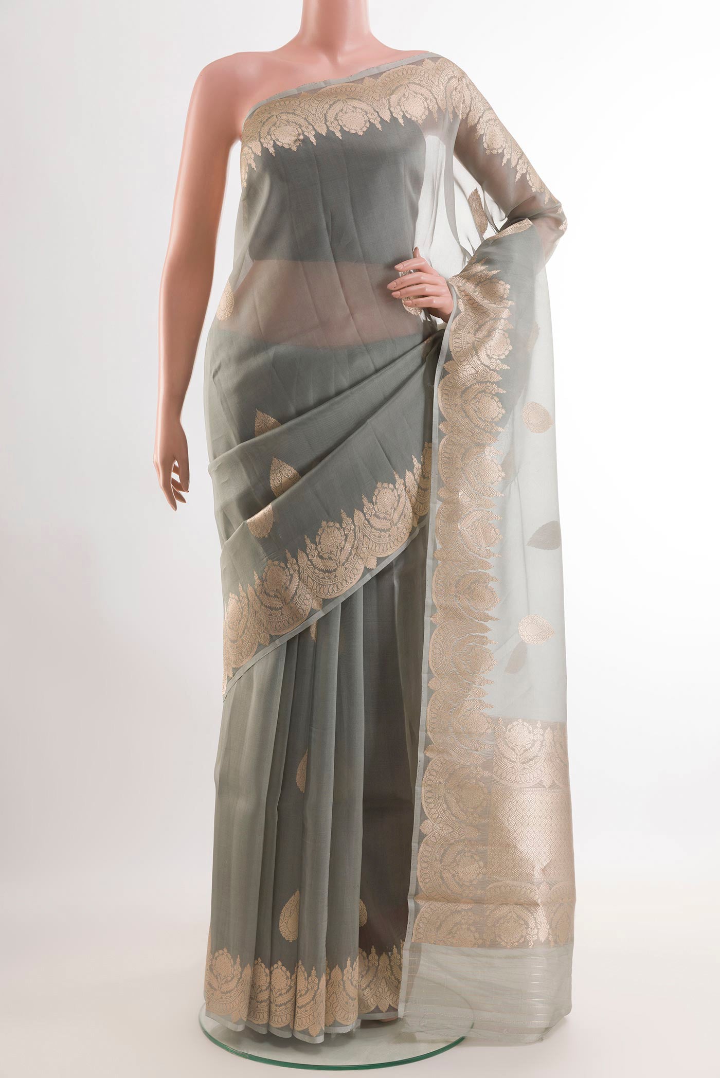 Grey Organza Silk Saree with Zari Butta on the body and Zari Border.  displayed on a mannequin
