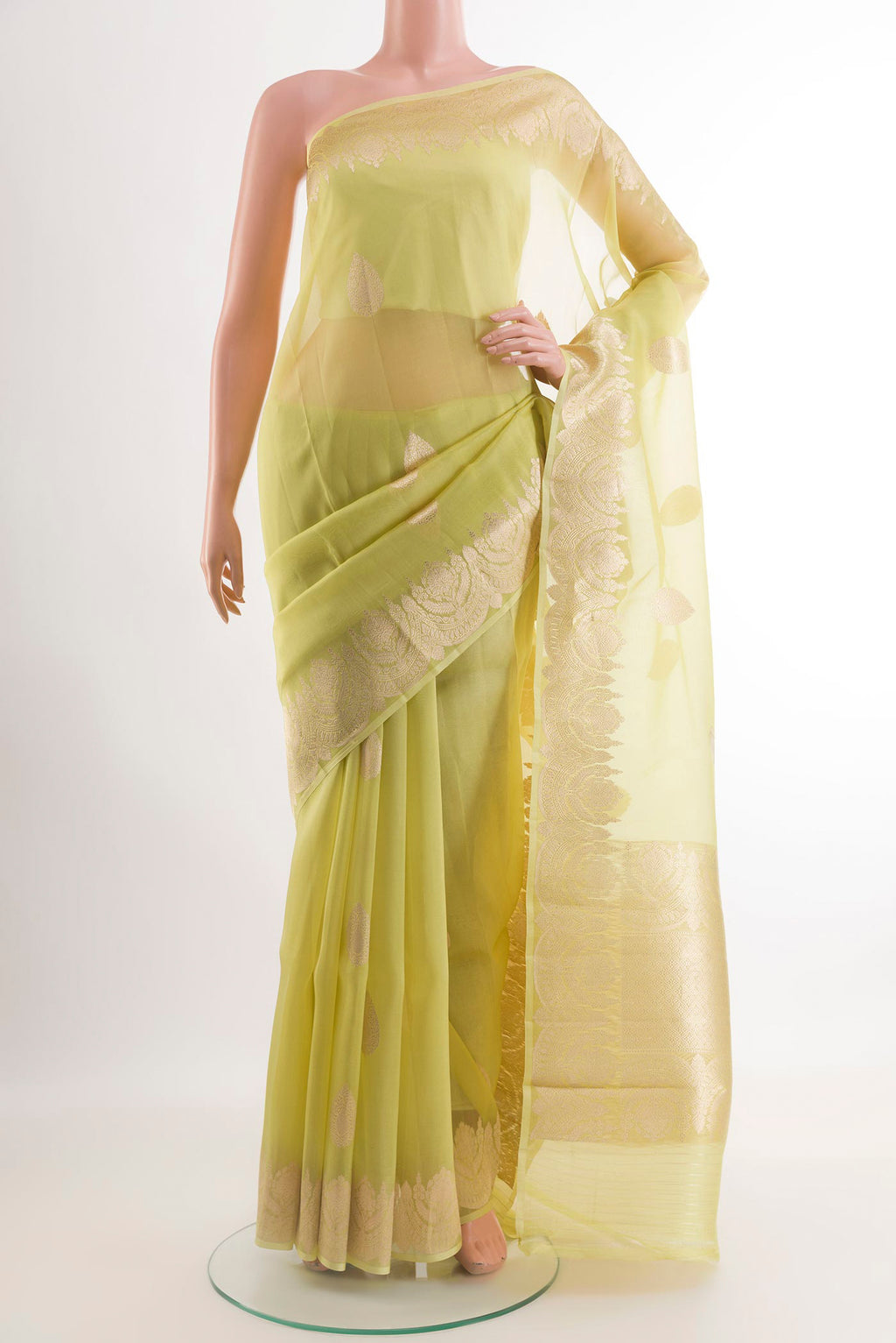 Green Organza Silk Saree with Zari Butta on the body and Zari Border.  displayed on a mannequin