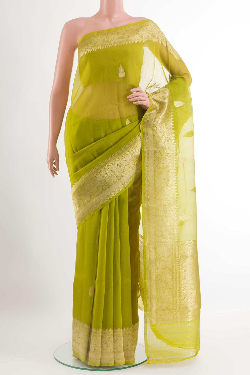 Green Organza Silk Saree with Zari Butta on the body and Zari Border.  displayed on a mannequin