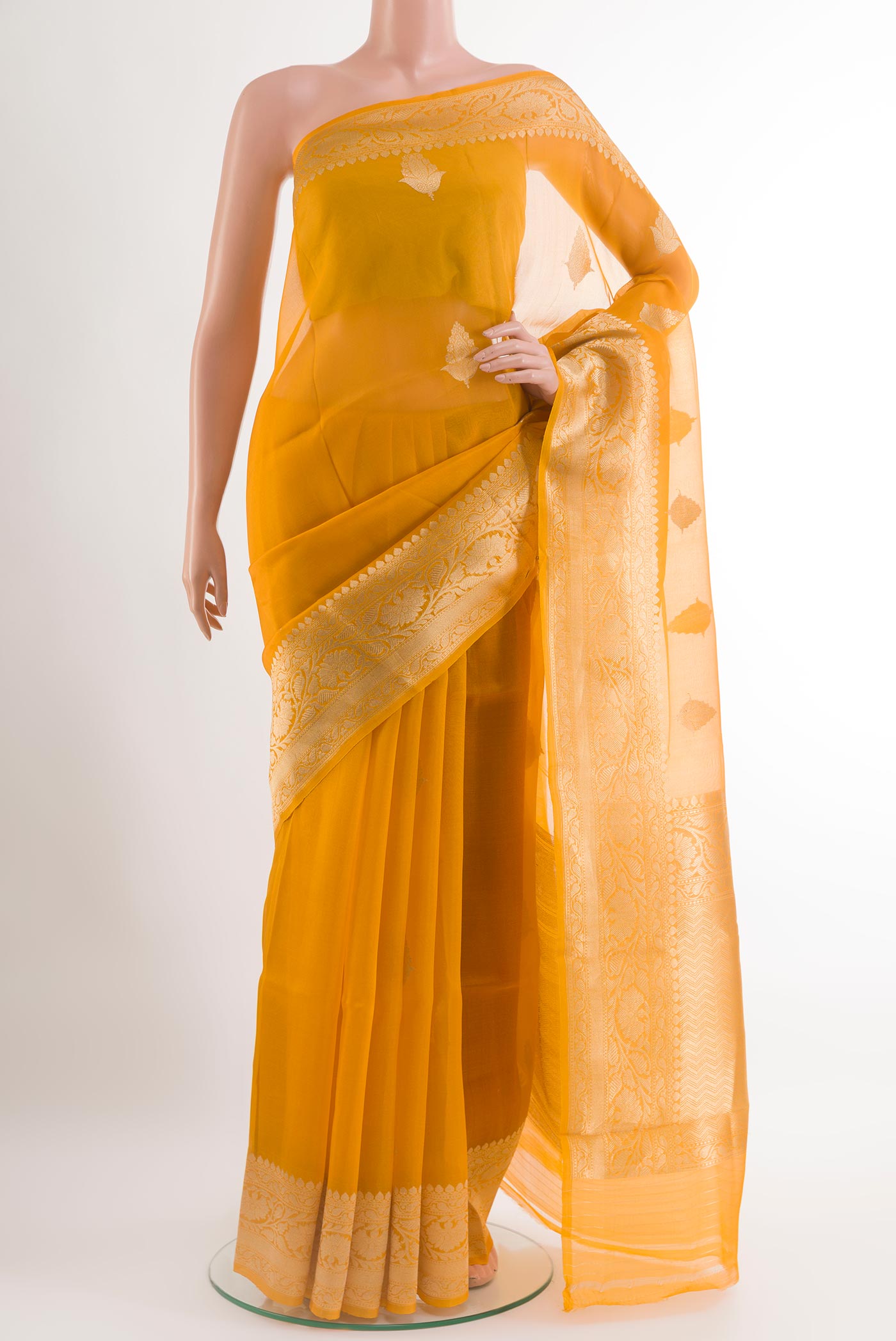 Yellow Organza Silk Saree with Zari Butta on the body and Zari Border.  displayed on a mannequin