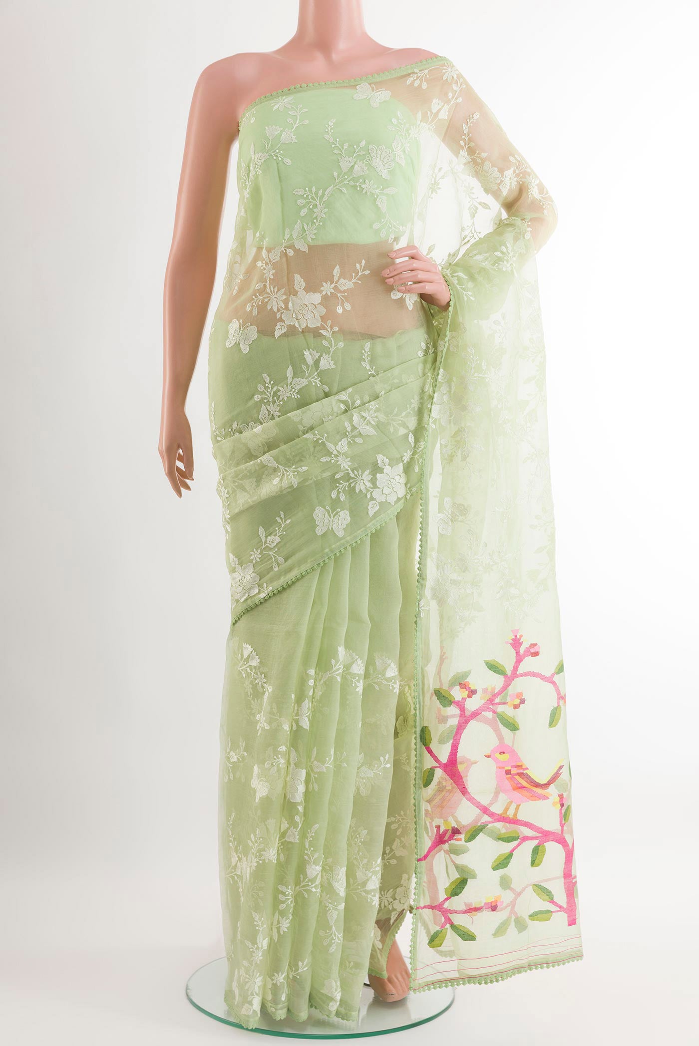 Green Organza Silk Saree with Embroidery on the body and Embroidery Border.  displayed on a mannequin