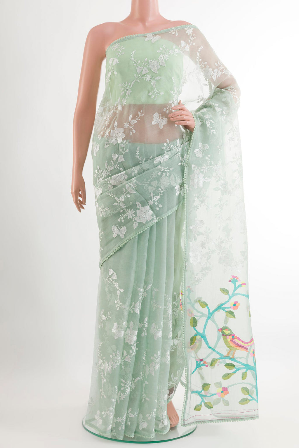 Green Organza Silk Saree with Embroidery on the body and Embroidery Border.  displayed on a mannequin