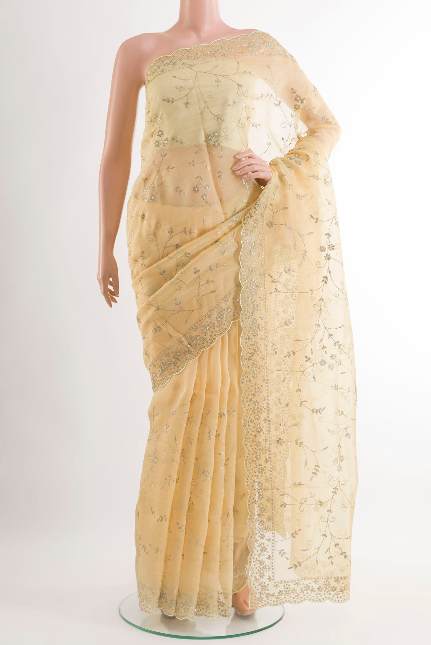 Yellow Organza Silk Saree with Embroidery on the body and Embroidery Border.  displayed on a mannequin