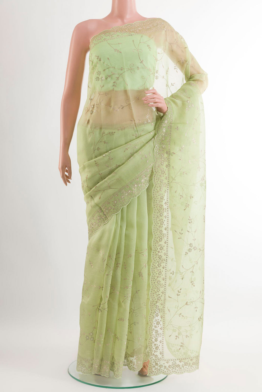 Green Organza Silk Saree with Zari Butta on the body and Embroidery Border.  displayed on a mannequin
