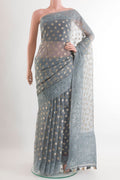 Grey Organza Silk Saree with Zari Butta on the body and Embroidery Border.  displayed on a mannequin